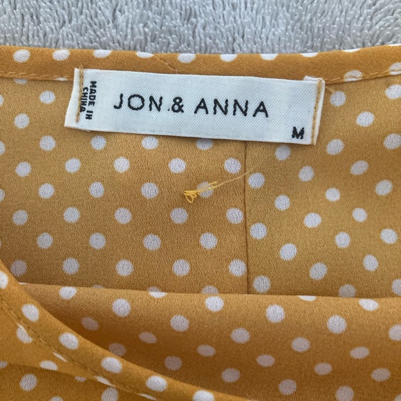 Yellow with white polka dots and button up closure in back. Size medium. - Picture 5 of 5